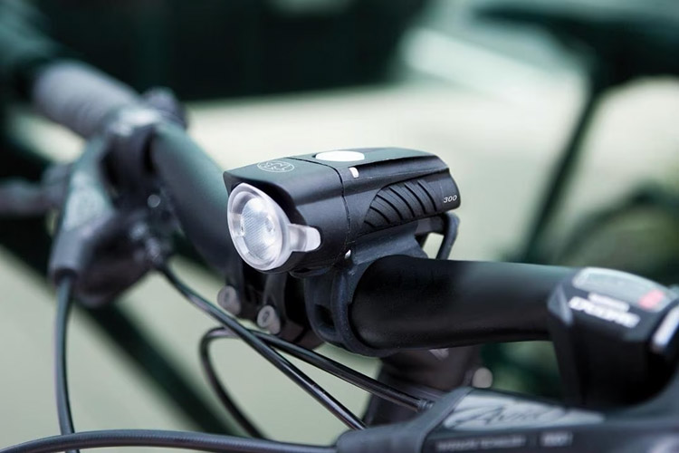 black front bike light mounted on a bike handlebar