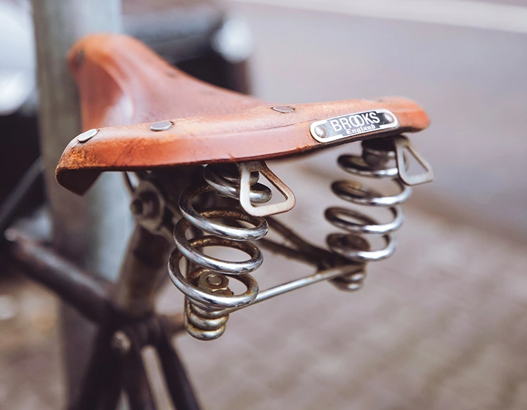a closeup of a brooks comfortable bike saddle
