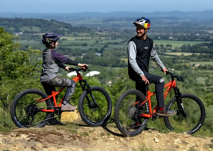 child riding 24 inch mountain bike with father