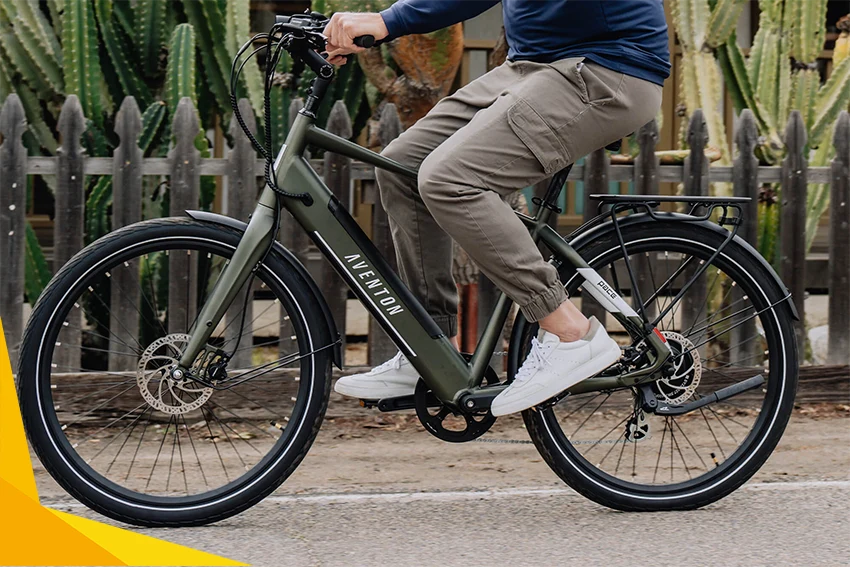 man riding green aventon pace 500.3 ebike