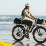 woman riding a lectric xpeak ebike along the beach