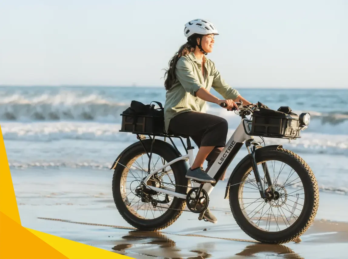 woman riding a lectric xpeak ebike along the beach