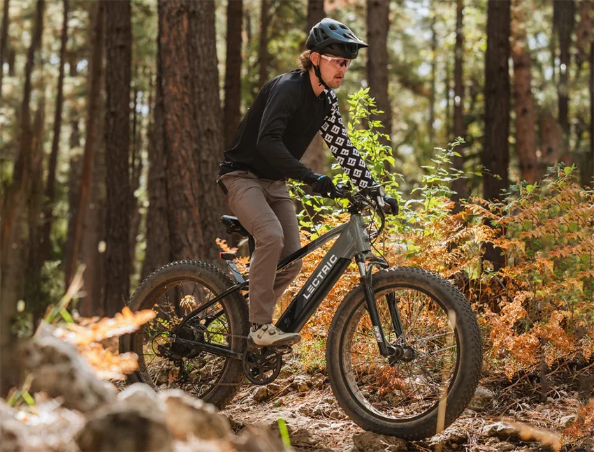 man riding lectric xpeak fat tire bike in the forest