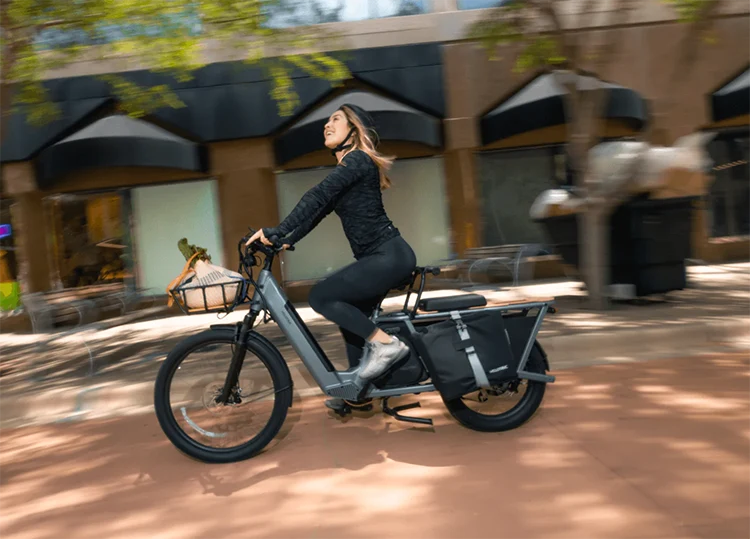 woman riding a velotric electric cargo bike