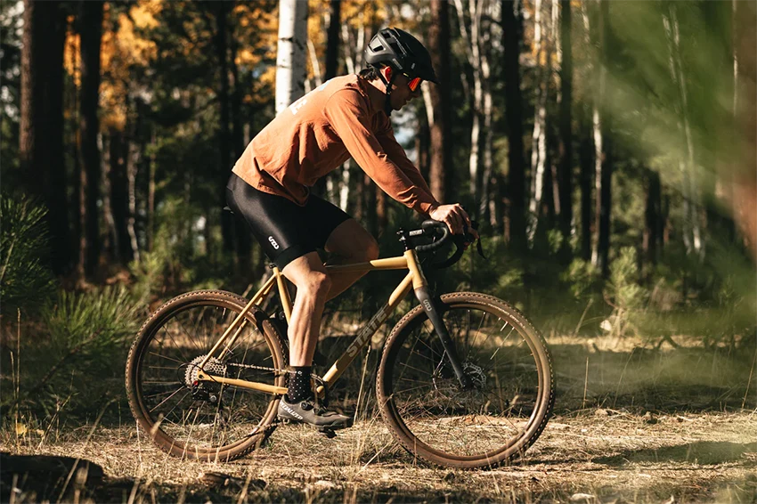 male cyclist riding a state gravel bike with 650b wheels