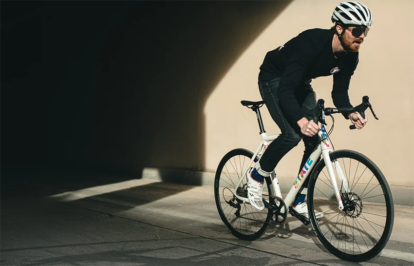 man riding a road bicycle with a 700c wheel size