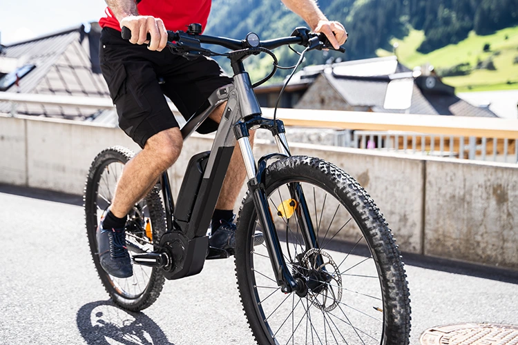 man riding a mountain bike made by the best electric bike brand