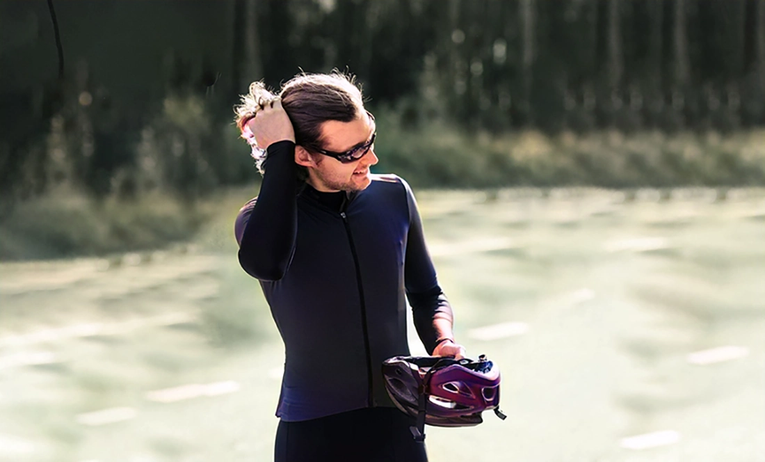 a cyclist with helmet hair after taking off his helmet