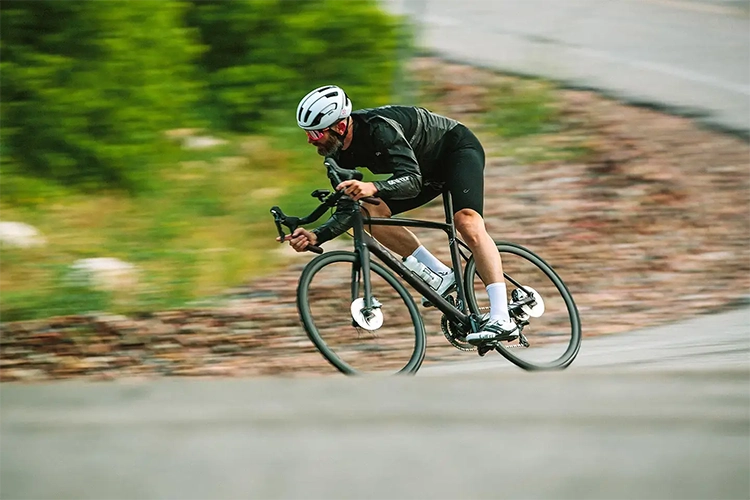 man riding a vaast road bike at high speed